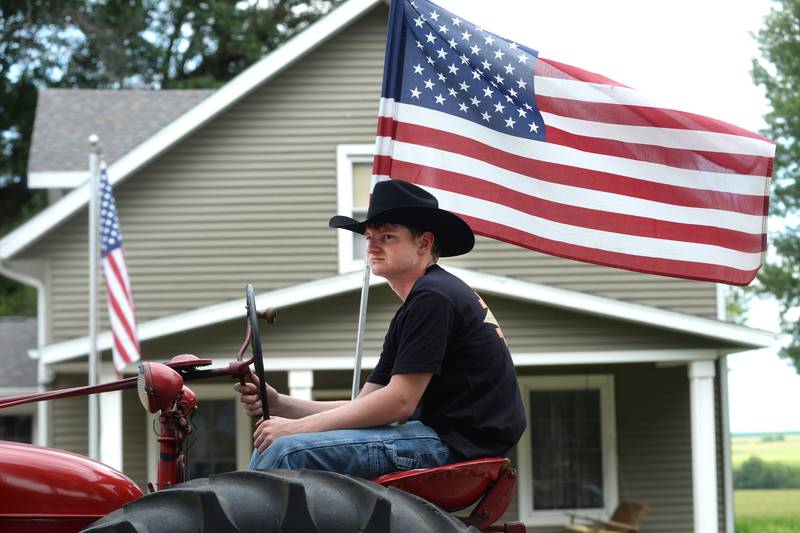 Bryce Miller drives a 1947 Farmall M tractor in the German Valley Days parade on Saturday, July 20, 2024. The tractor is owned by Norman and Eunice Miller.