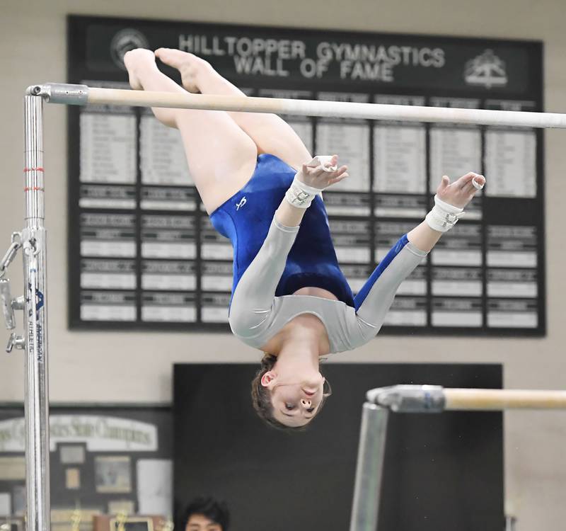 Glenbard South’s Charlotte Moran on the uneven parallel bars at the Glenbard West girls gymnastics regional meet in Glen Ellyn on Wednesday, January 31, 2024.