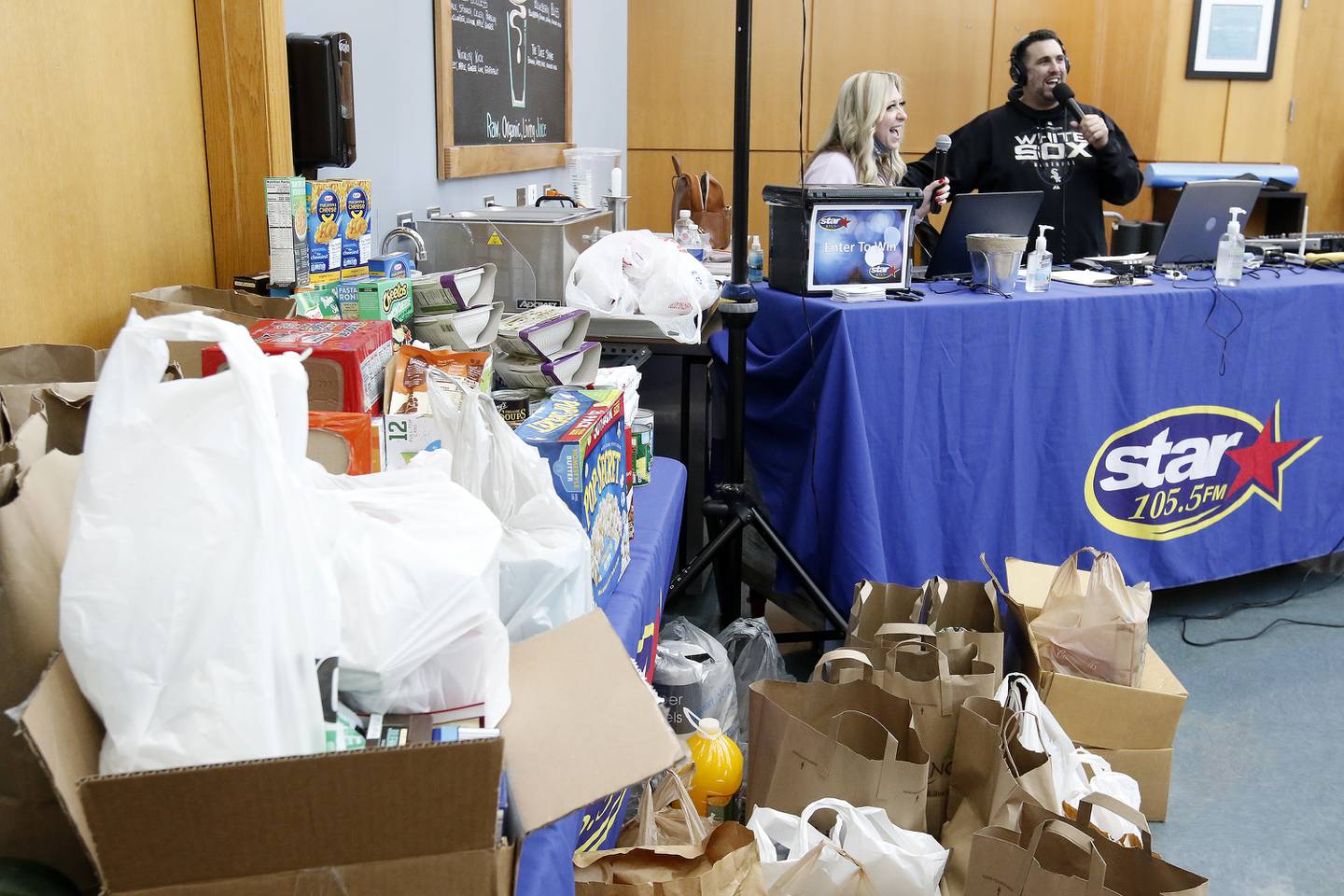 Star 105.5 radio hosts Tina Bree, left, and Joe Cicero help draw in donations during a Community Harvest food drive on Friday, Nov. 19, 2021, at Northwestern Medicine Health and Fitness Center in Crystal Lake. About 40 sponsoring sites helped contribute to the annual food collection and donation campaign for the Crystal Lake Food Pantry.