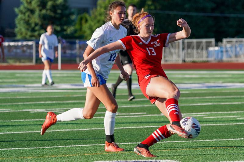 Naperville Central's Emma Russell (13) plays the ball against St. Charles North's Kyra Treanor (12) during a Class 3A St. Charles North Supersectional soccer final match at St. Chatles North High School on Tuesday, May 28, 2024.