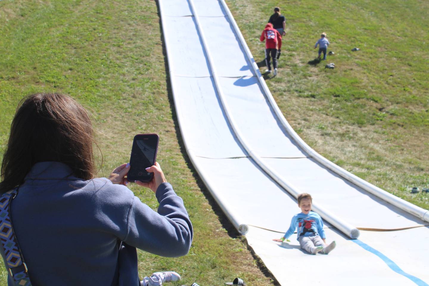 Children slide down one of the Richardson Adventure Farm giant slides on Sept. 7, 2024.