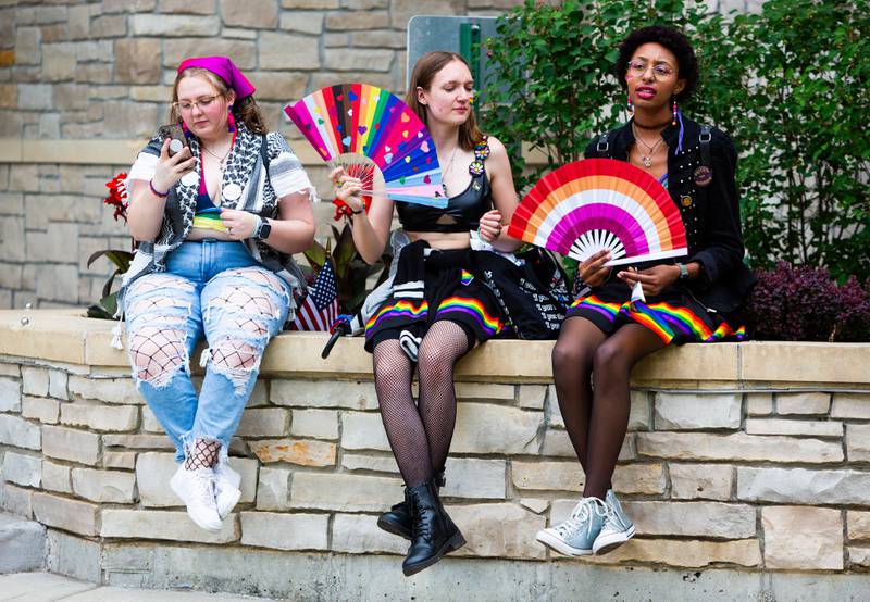 (L to R) Ally Krause, Hannah Brown, and Briana Parish wait for the pride dog and human parade to begin during the Downer’s Grove Pride Fest on Saturday, June 8, 2024.