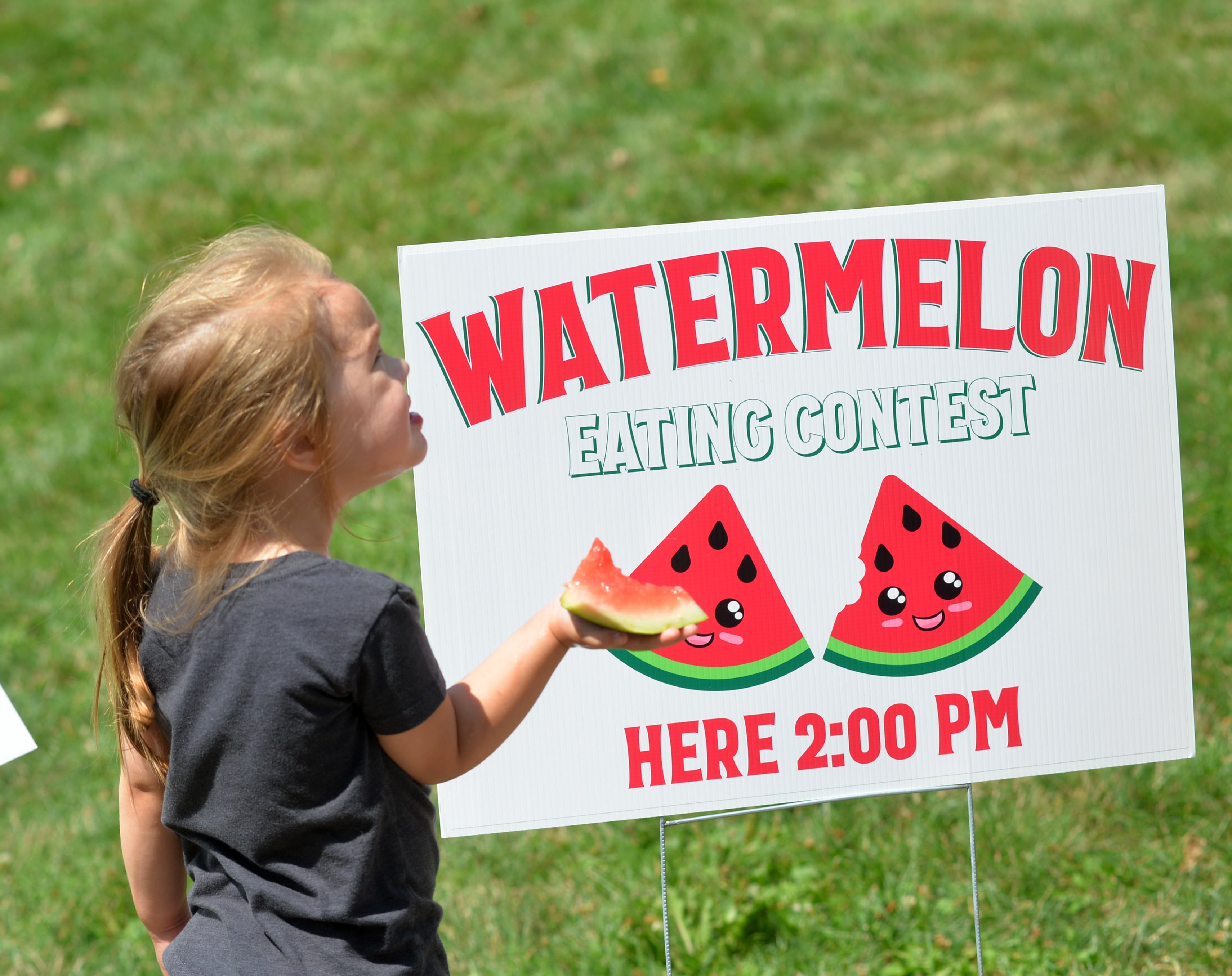 RJ Hanson, 3, of Forreston, hold her little piece of watermelon while attending Forreston Sauerkraut Days' Watermelon Eating Contest on Saturday, Aug. 5. 2023.