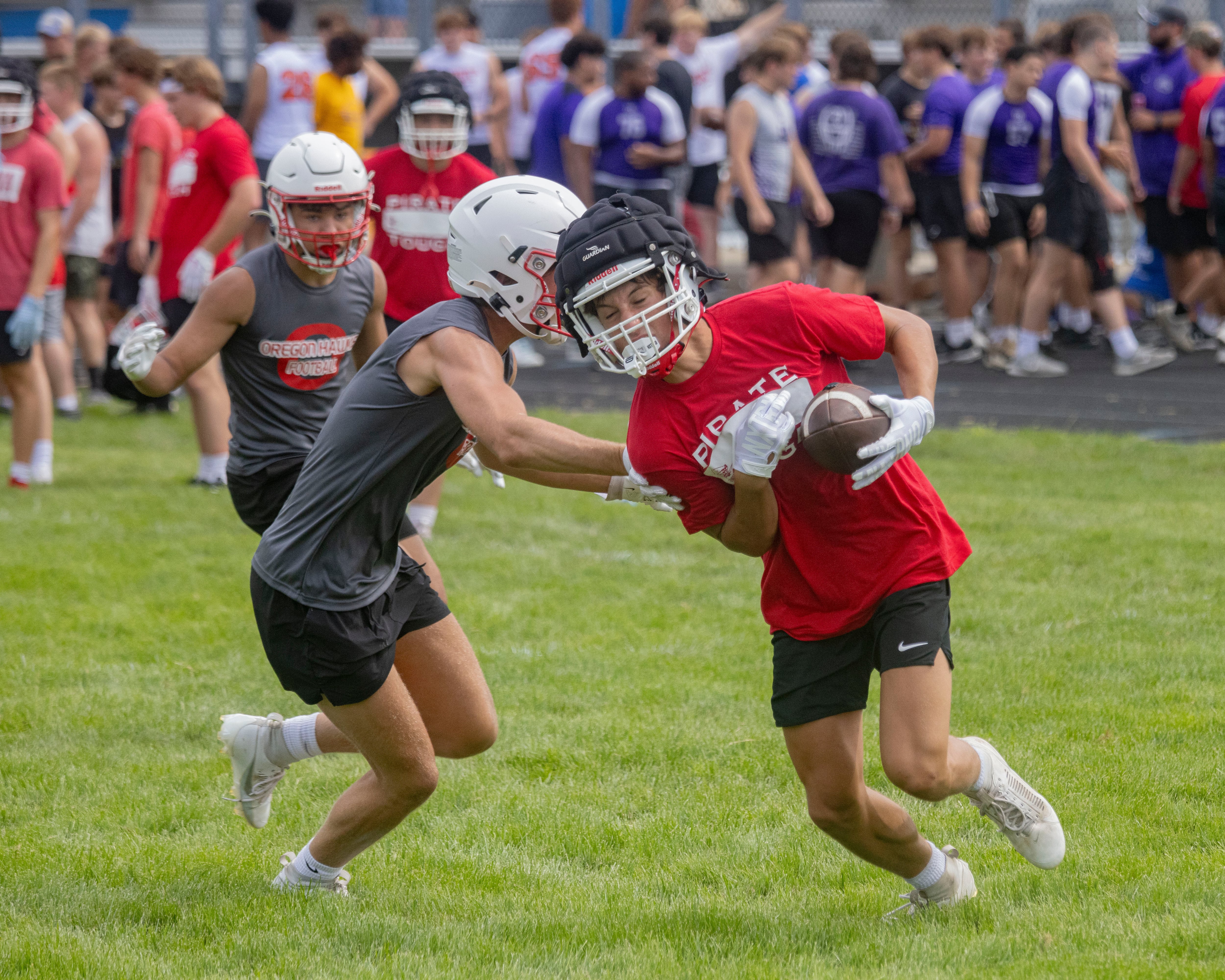 Joey Liebhart of Ottawa High School runs downfield against the Oregon defender during a multiple high school practice football meet at Princeton High School on July 20, 2024.