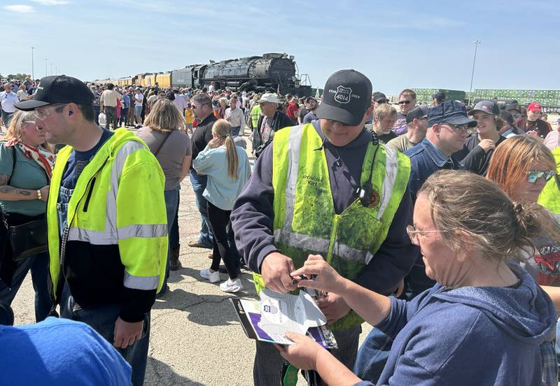 Kirt Clark, a member of the "steam team" that operates the Union Pacific's Big Boy 4014 vintage steam locomotive signs his autograph at the UP Global II terminal on Sunday, Sept. 8, 2024 during the daylong, free event in Rochelle.