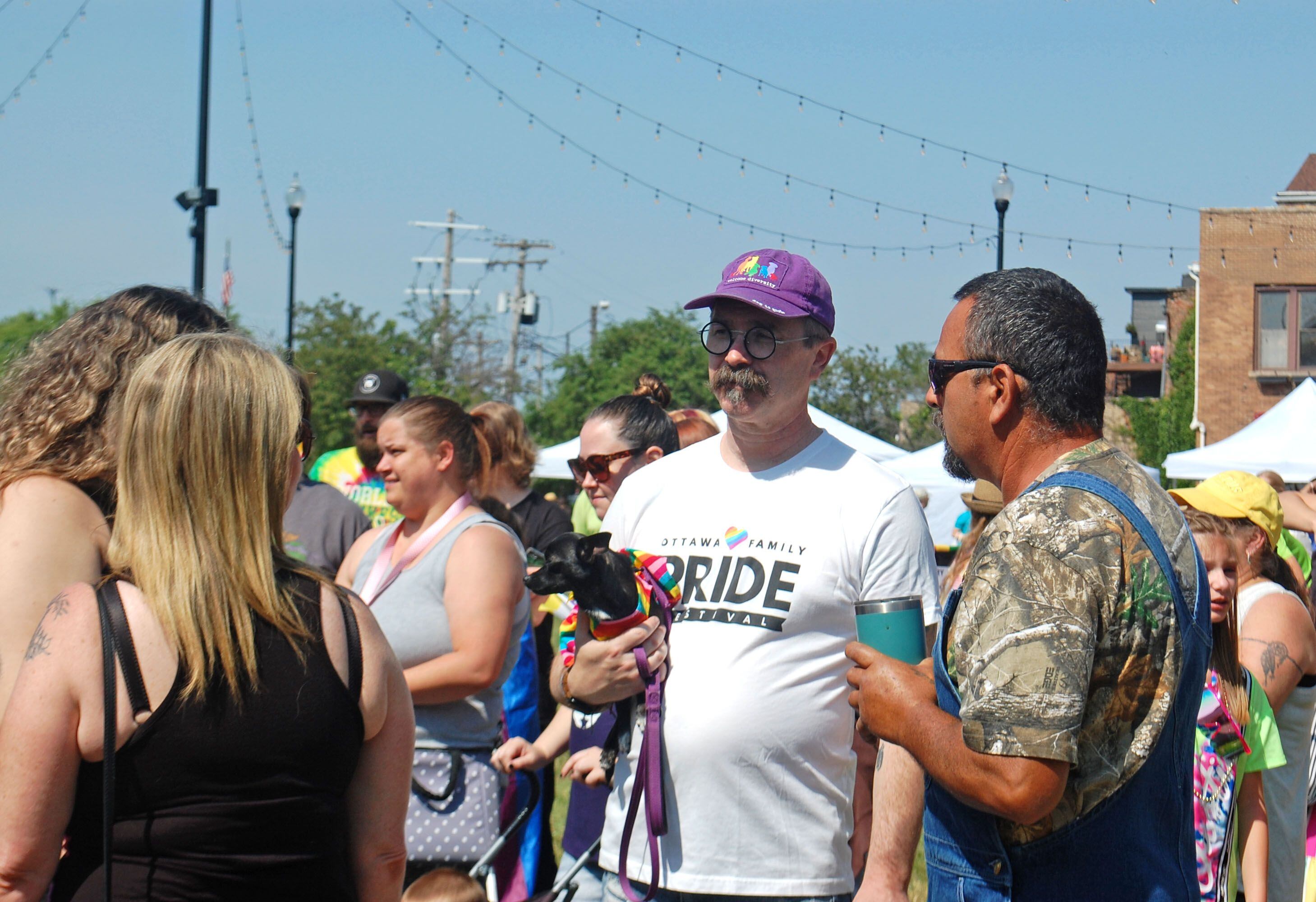 Ottawa mayor Robert Hasty (in white shirt) talks with other visitors at the second annual Ottawa Family Pride Festival in the downtown Ottawa Jordan block on Saturday, June 10, 2023.