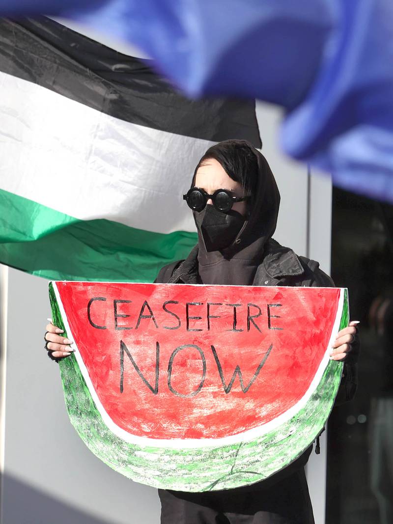A protester holds a sign during a rally against the Israel–Hamas war Thursday, Feb. 29, 2024, outside the Holmes Student Center at Northern Illinois University of DeKalb.