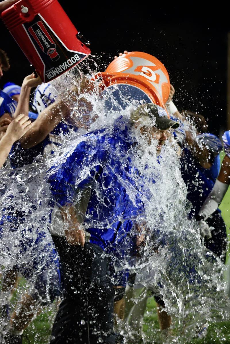 Princeton players douse coach Ryan Pearson after he recorded his 100th career win with Friday's 57-20 win over Mercer County at Bryant Field.