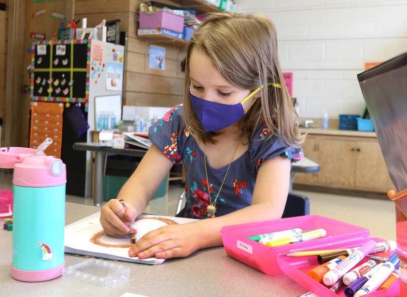 Southeast Elementary School first grader Finley Johnson works on a project in her classroom Wednesday at the school in Sycamore. Wednesday was the first day at the school that some students were able to attend in-person classes as part of a hybrid learning plan.