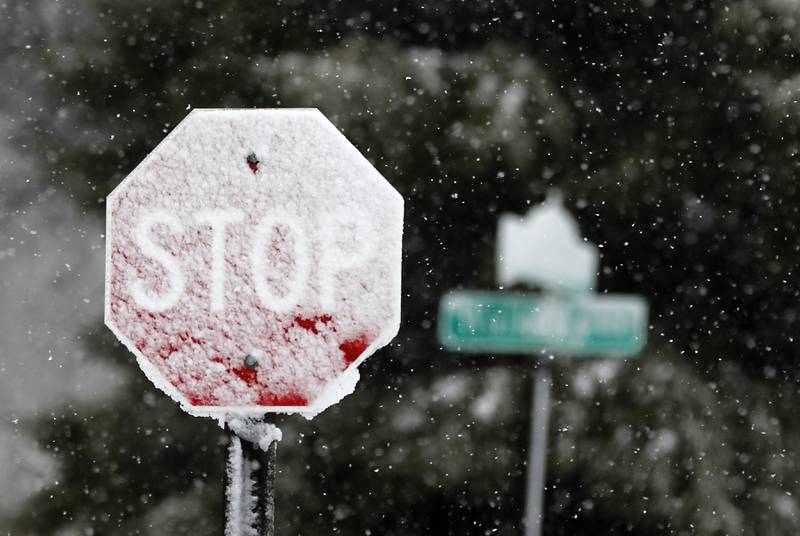 Snow sticks to a stop sign along Walkup Avenue  near Veterans Acres Park as a winter storm moves through McHenry County on Tuesday, Jan. 9, 2024, delivering snow to most of the county.