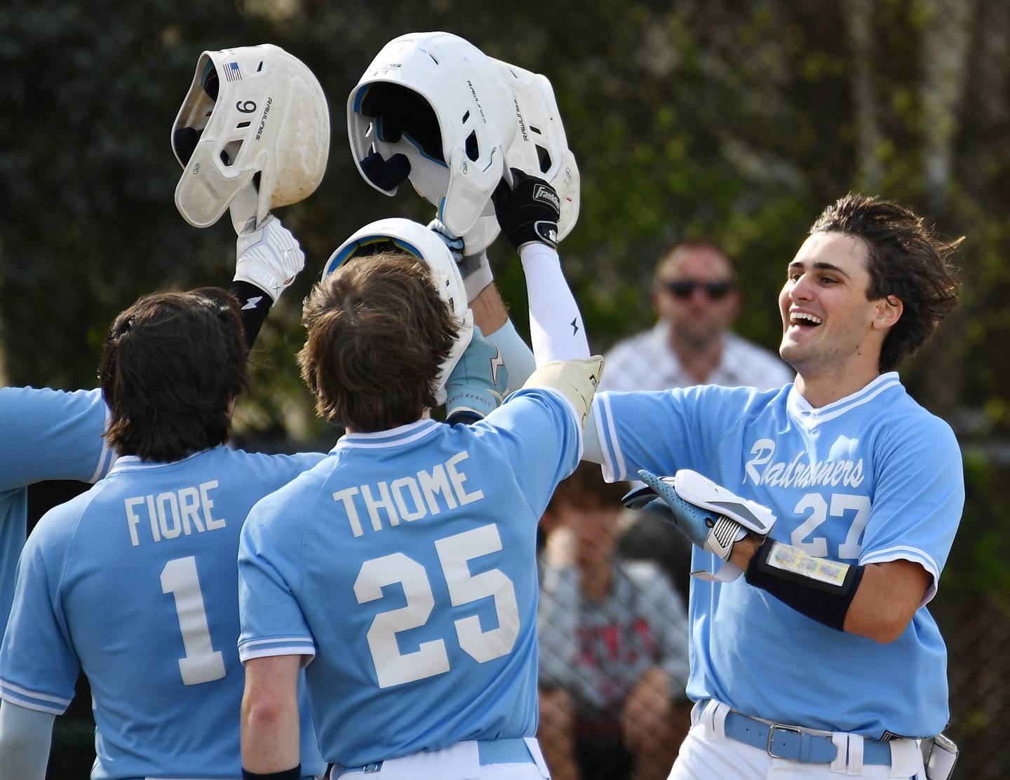 David Cox (right) celebrates with Nazareth Academy teammates after his two run home run in the first inning of a game against Benet on April 22, 2024 at Benet Academy in Lisle.