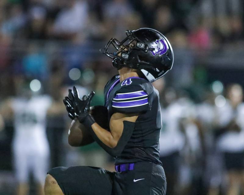 Downers Grove North's Caden Chiarelli (4) fields a punt during a football game between Glenbard West at Downers Grove North on Friday, Sept 13th, 2024  in Downers Grove.