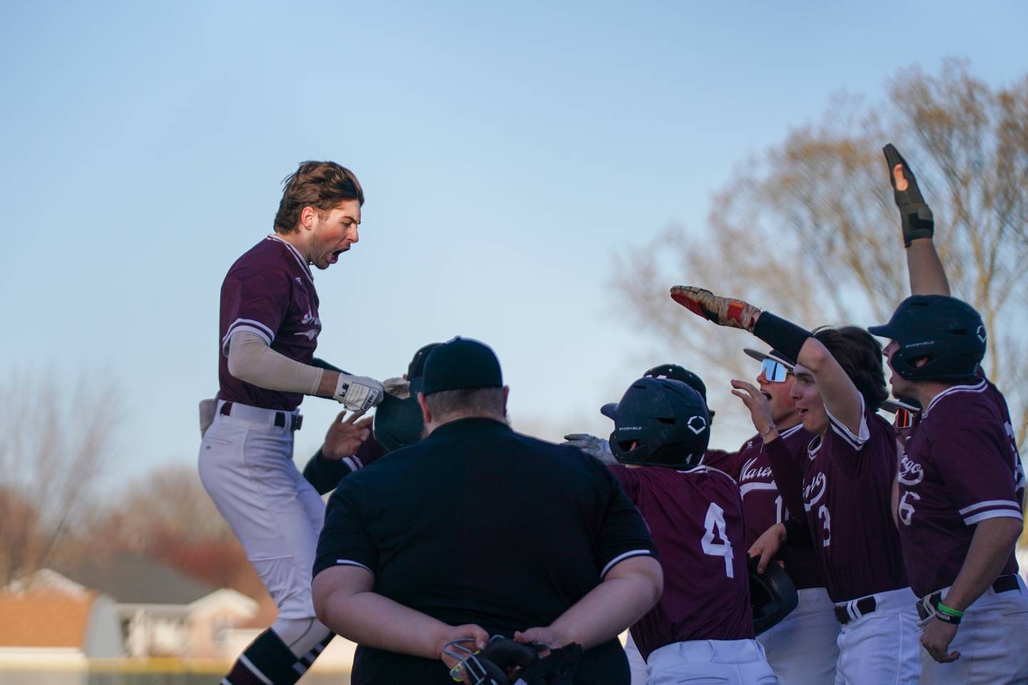 Marengo's Michael Kirchhoff (5) leaps on to home plate after hitting a three-run homer against Plano during a baseball game at Plano High School on Monday, April 8, 2024.