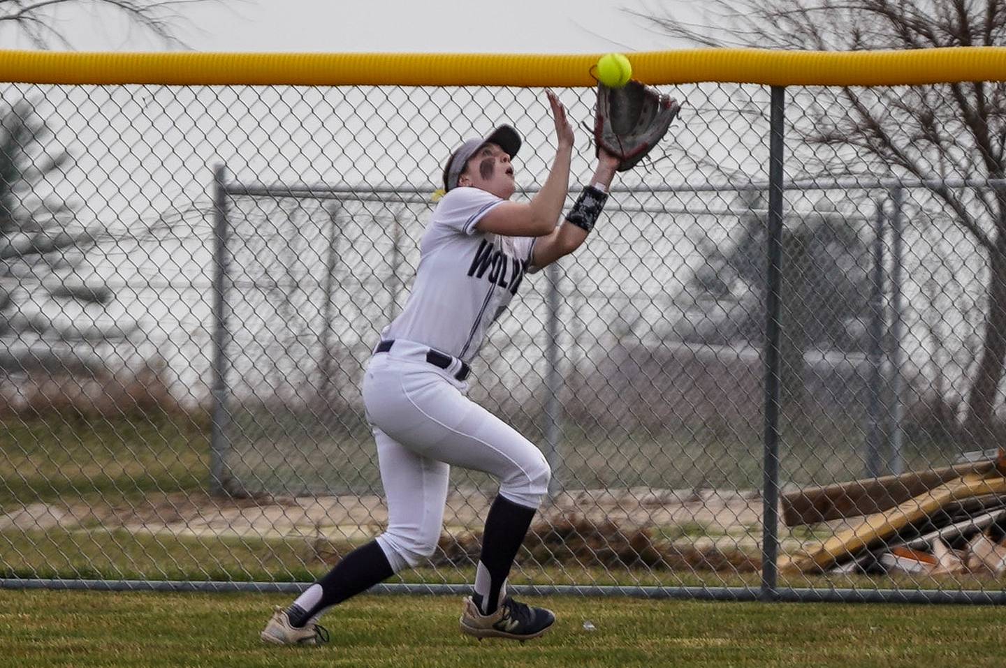 Oswego East's Finley Anderson (15) catches a fly ball for an out against St. Charles East during a softball game at Oswego East High School on Wednesday, March 13, 2024.