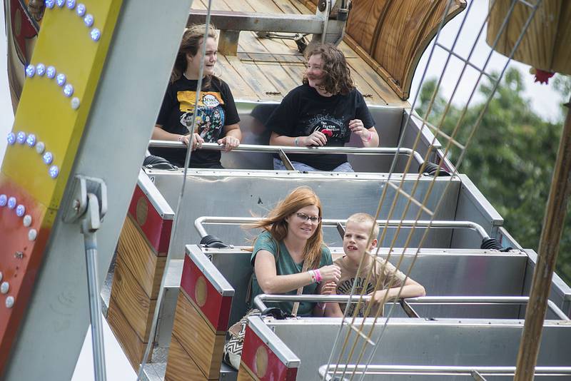 Melissa Kuhl and son Jacob Miller, 12, of Milledgeville hang on for a ride at the Saturday, Aug. 13, 2022, at the Carroll County fair in Milledgeville.