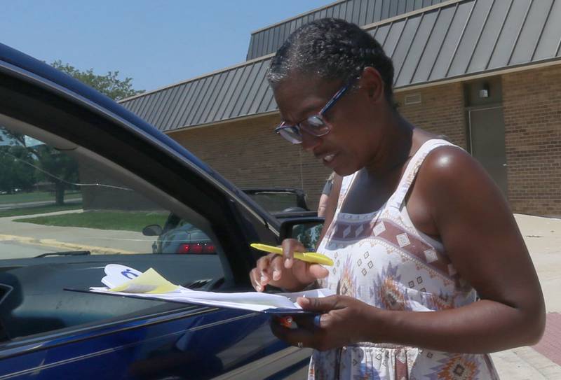 Carolyn Tyler-Garcia takes food orders at  Sheppard Middle School on Wednesday, July 17, 2024 in Ottawa. The Summer Meal program provides two meals per day. The program is held every Wednesday from 10a.m.-1p.m. at the school. You must order the meal bags by clicking on the links posted on the Shepard Middle School Facebook page.