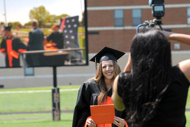 Alexis Brennen gets her picture taken during Sandwich High School's graduation ceremony on the football field, Sunday, May 19, 2024.