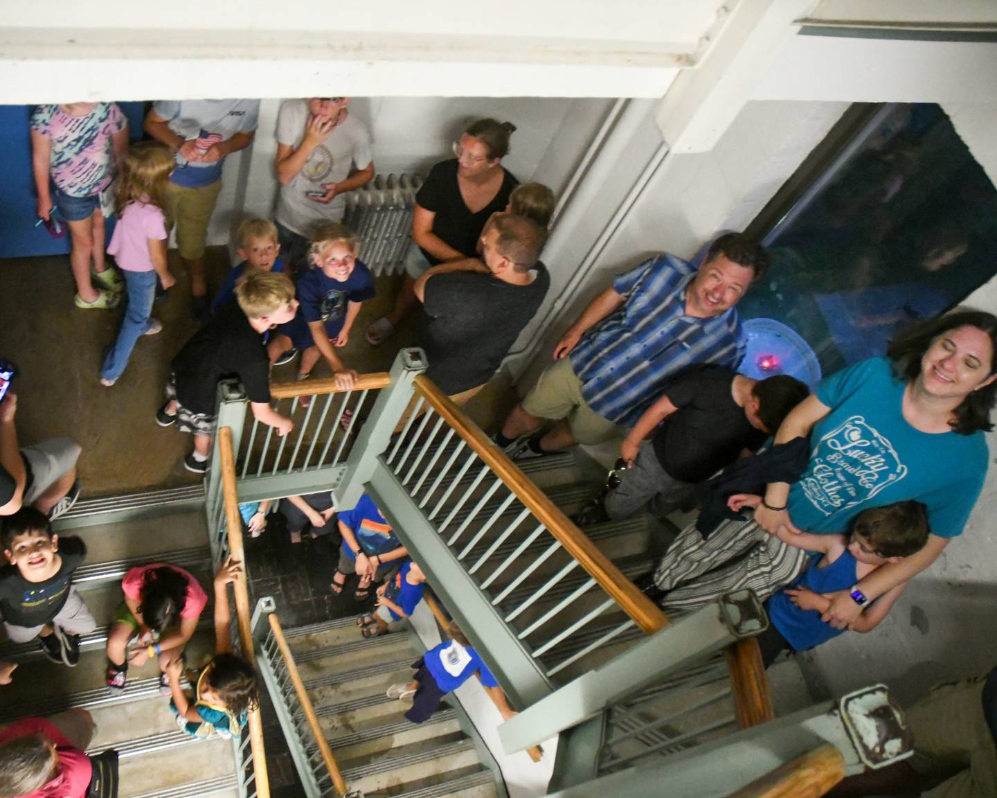 Community members wait their turn on the staircase of the Davis Hall Observatory in DeKalb to look through the telescope. The observatory reopened after a three-year hiatus during a Star Party Wednesday, Aug. 2, 2023 in DeKalb.