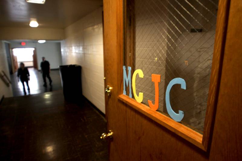 Congregation members walk through a downstairs hall as the McHenry County Jewish Congregation held a deconsecration ceremony at their Ridgefield Road location in preparation for a move to the Tree of Life Unitarian Church in McHenry on Sunday, August 18.