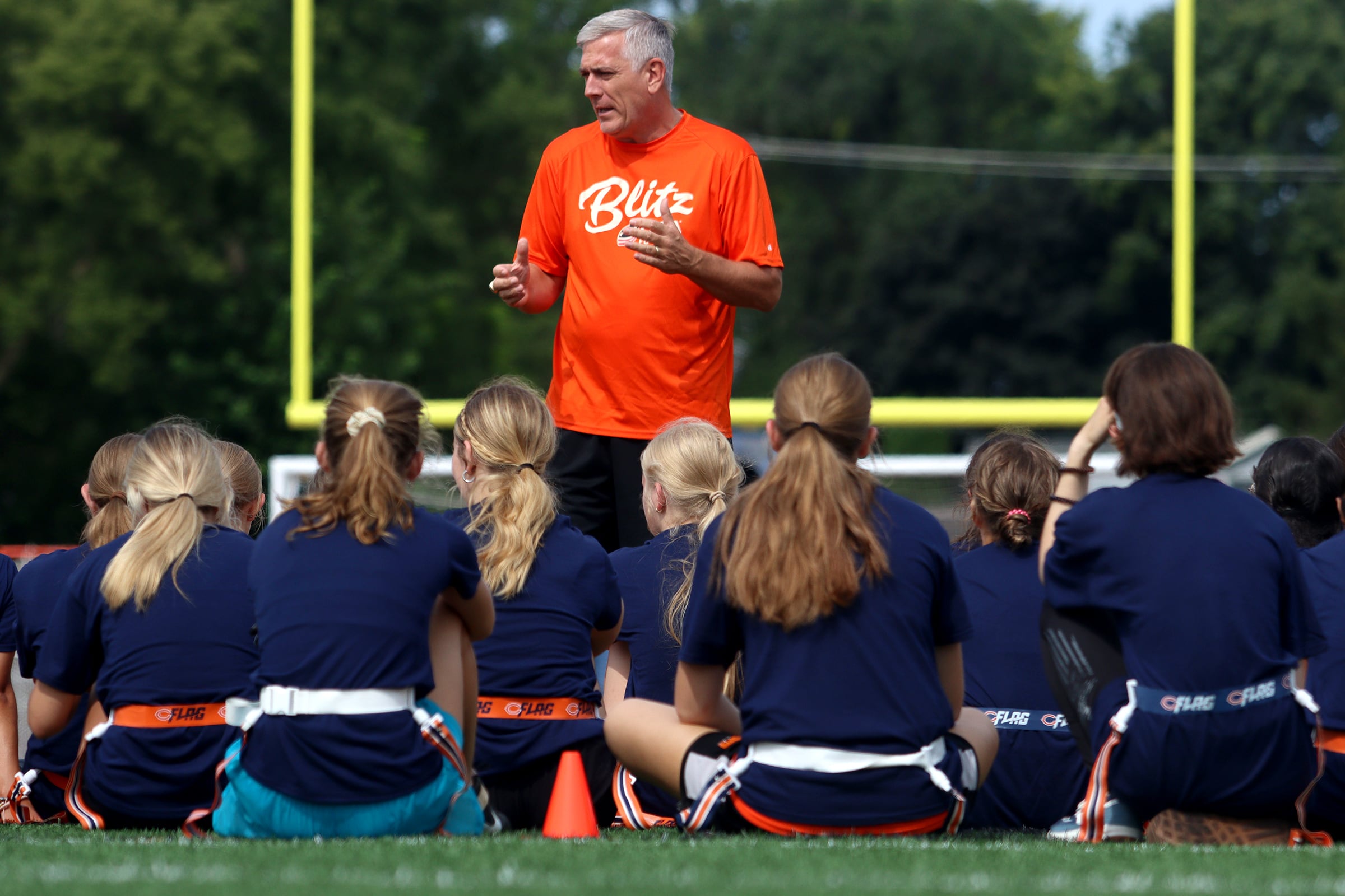 Bears former player Jim Schwantz speaks as the Chicago Bears and McHenry Community High School hosted a flag football clinic at McCracken Field Wednesday, July 31, 2024.