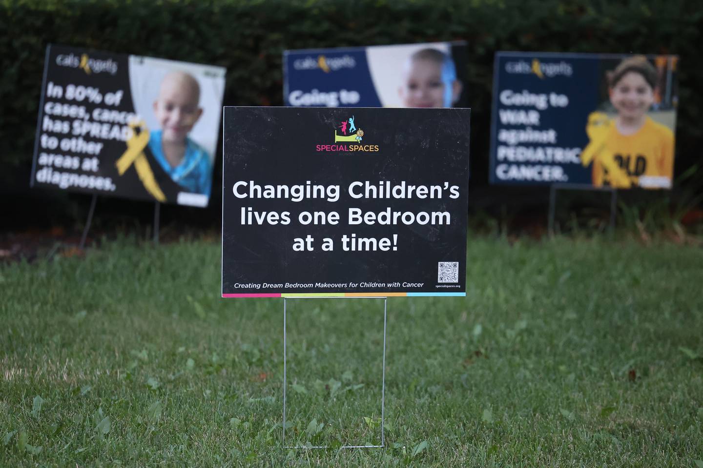 A sign for the non-profit organization Special Places sits in the front yard of the Espinoza family along with signs for Pediatric Cancer awareness. Jorgie Espinoza, who is battling cancer, won an extreme bedroom makeover from Special Places, an organization creating dream bedrooms for children with cancer on Tuesday, Sept. 12, in Joliet.