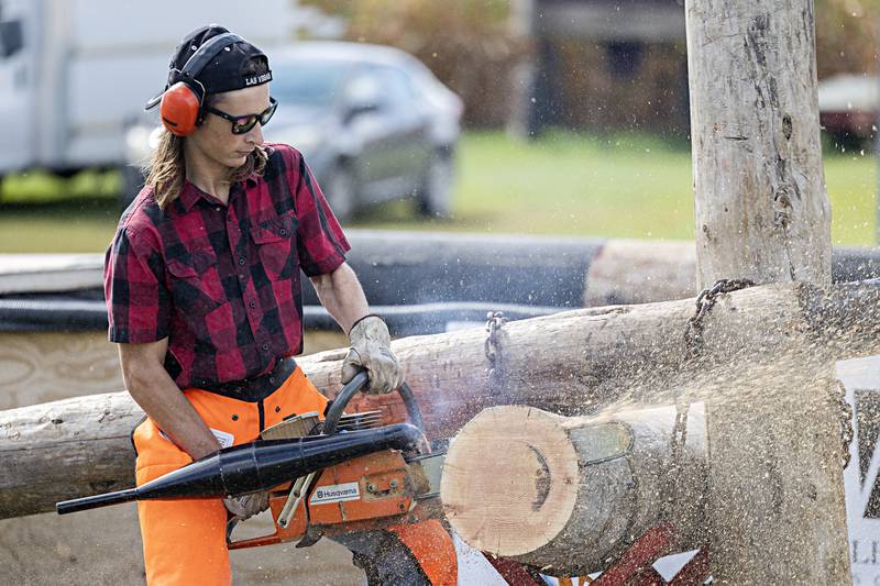 Brett Wells fires up the hot saw, a souped up chainsaw, for an event in a lumberjack competition in Rock Falls Saturday, Oct. 7, 2023.