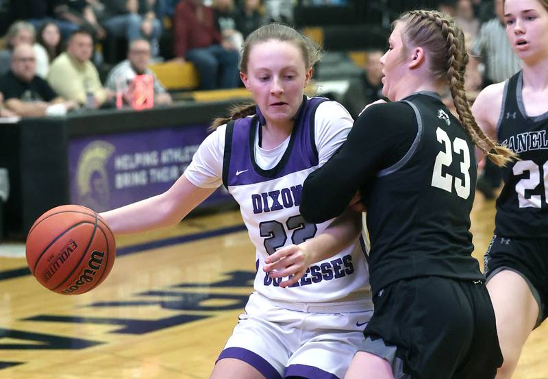 Dixon’s Katie Drew drives into Kaneland's Kendra Brown Thursday, Feb. 22, 2024, during their Class 3A sectional final game at Sycamore High School.