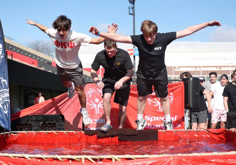 Members of the Phi Kappa Psi fraternity bellyflop into the water on a cold and windy Saturday, Feb 17, 2024, during the Huskie Stadium Polar Plunge at Northern Illinois University in DeKalb. The Polar Plunge is the signature fundraiser for Special Olympics Illinois.