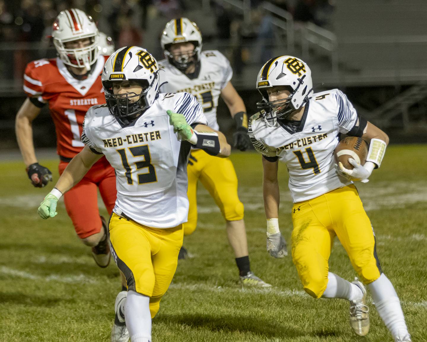 Led by a block from Brady Tyree (13), Reed-Custer's Landen Robinson (4) searches for a hole in the Streator defense Friday, Oct. 18, 2024, at Doug Dieken Stadium.