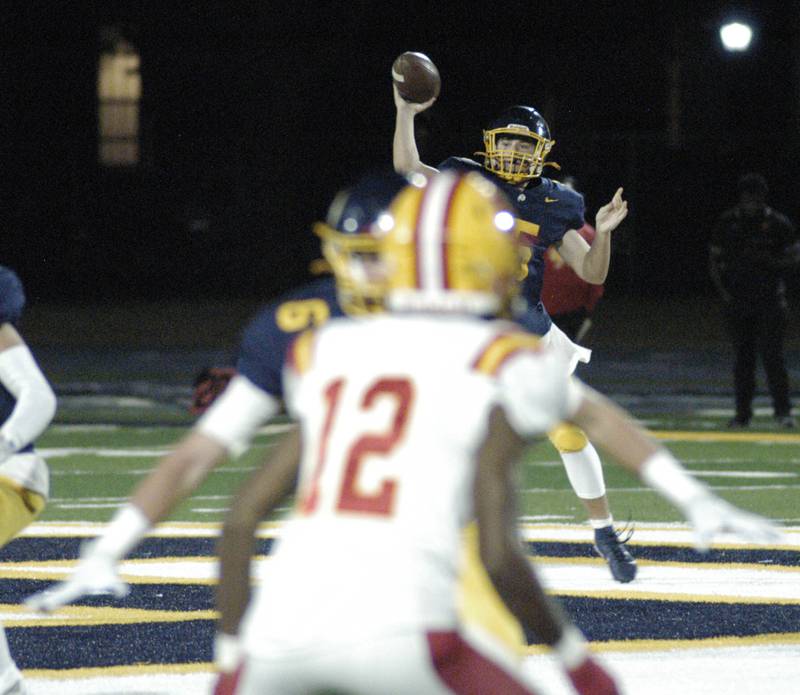 Rock Island QB  Jae'vion Clark-pugh   slips an outstreatched arrn of Cobey Shipma  of Sterling.   Action took place on Friday, October  18th, 2024 in Sterling.