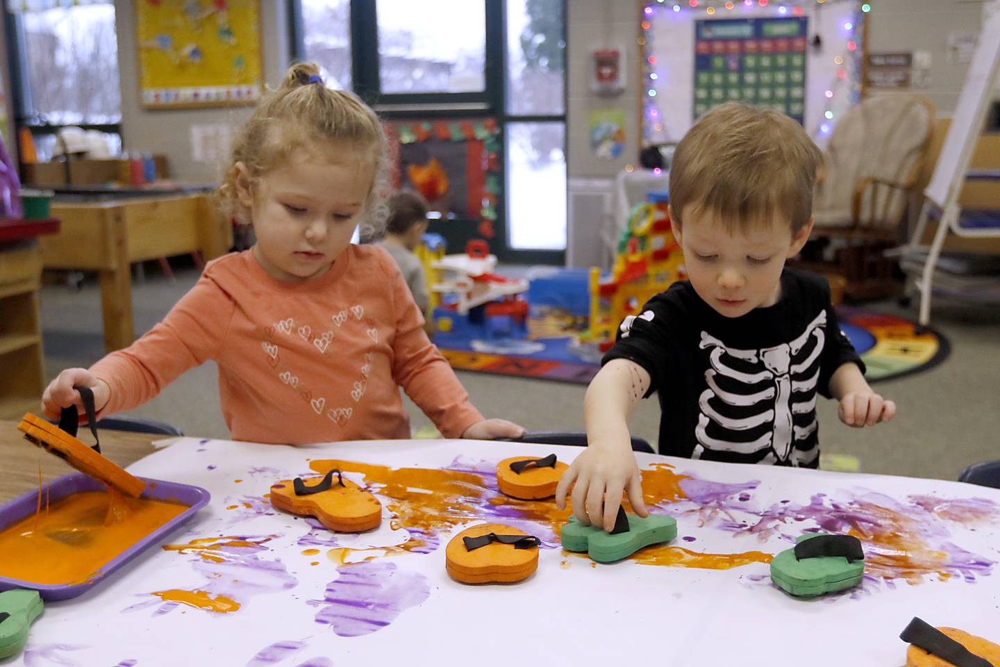 Avery and Maverick play with stamps on Tuesday Jan. 23, 2024, at the Purple Moose in Crystal Lake. The preschool will close down after the current school year finishes in June, unless the school can find another location after the Shiloh Church decided not to renew the preschool's lease.