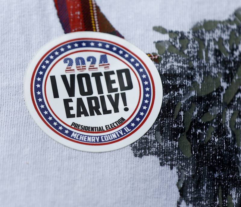 A man shows off his “I Voted Early” sticker  after voting at the McHenry County Election Center on Thursday Sept. 26, 2024, during the first day of early voting in McHenry County,