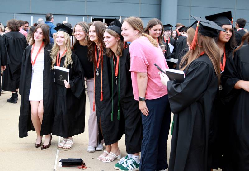 St. Charles East graduates pose for photos following the school’s 2024 commencement ceremony at Northern Illinois University in DeKalb on Monday, May 20, 2024.