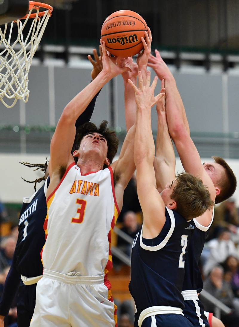 Batavia's Kyle Porter (3) battles three Downers Grove South players for a rebound during a Jack Tosh Classic game on Dec. 26, 2023 at York High School in Elmhurst.