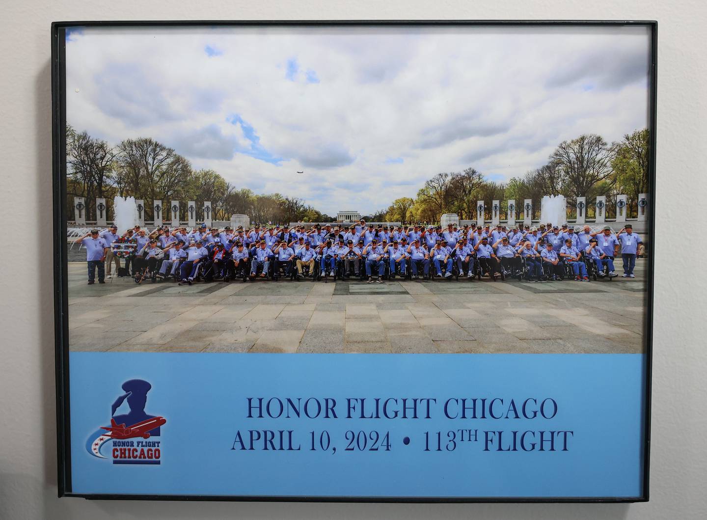 Jim McElroy’s 113th Honor Flight Chicago group photo hangs on his wall at his home in Morris on Tuesday, May 21, 2024.