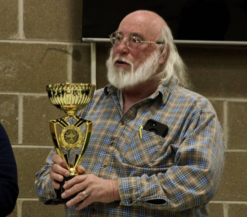 Jim Campbell holds the trophy on behalf of the Quad City Knomads, this year's champion for the Stupor Bowl trivia championship held Saturday, Feb. 11, 2023 at Reagan Middle School in Dixon.