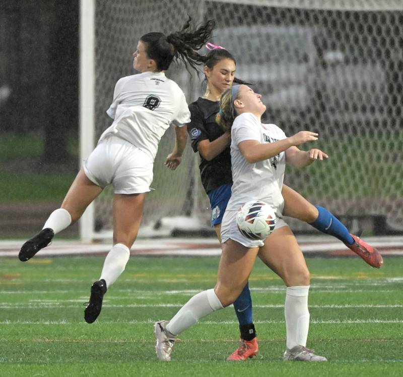 St. Charles North High School’s Kyra Treanor and Winnetka New Trier High School’s Charlotte Dellin and Addy Randall, right, all come together with the ball in the IHSA Class 3A championship game at North Central College in Naperville on Saturday, June 1, 2024.