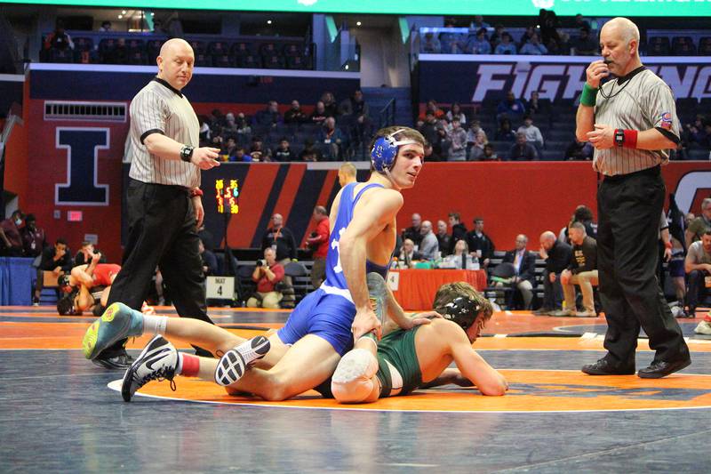 Newman's Carter Rude looks to his coaches during his 138-pound quarterfinal bout at the IHSA Individual State Finals on Thursday, Feb. 16, 2023 at State Farm Center in Champaign.