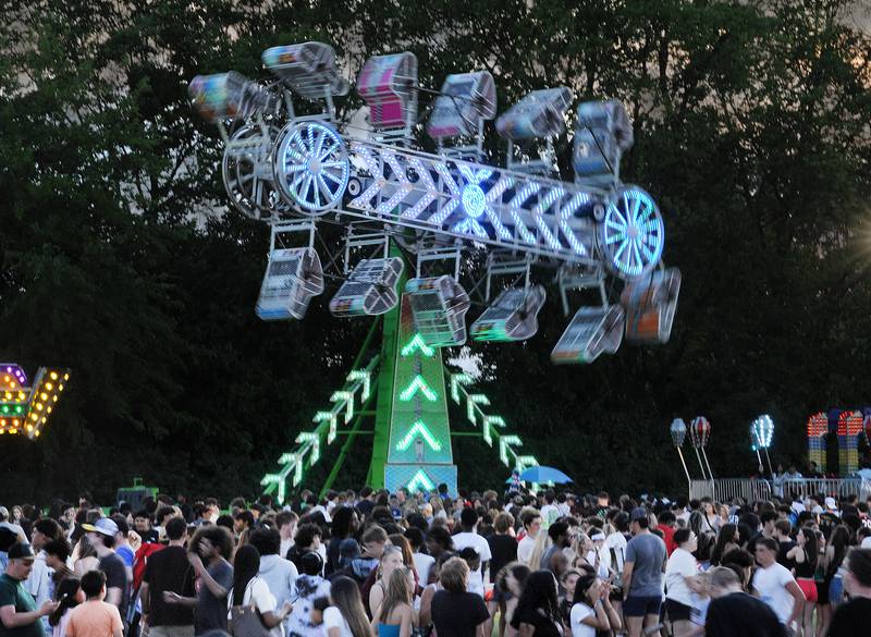 Crowds of teenagers and families with kids gather at the carnival rides during the Oswegoland Park District's PrairieFest on Friday, June 14, 2024.