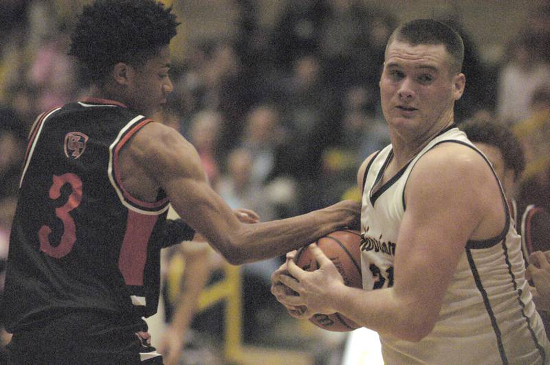 United Township player Dominic Rhoden grabs at the ball carried by Sterling's Lucas Austin during their game Friday, Feb. 9, 2024 at Sterling High School