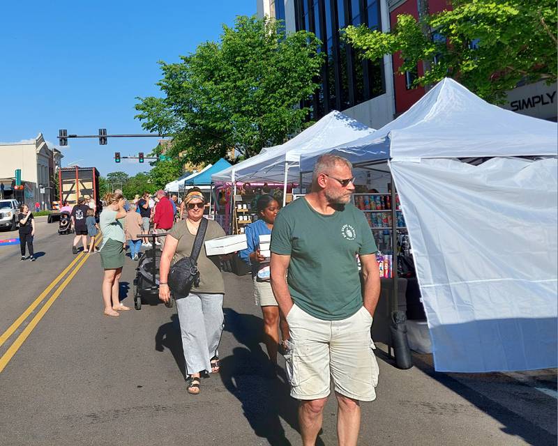 Visitors walk the opening Third Friday of the season Friday, May 17, 2024, on Madison Street in downtown Ottawa.