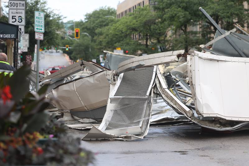 A large section of a roof blocks off East Cass Street after a storm blew through Joliet Sunday morning, July 14, 2024.