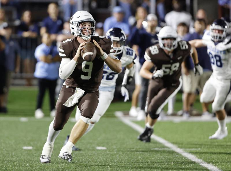 Mt. Carmel's Jack Elliott (9) scrambles looking for a receiver during the varsity football game between Nazareth Academy and Mt. Carmel high school on Friday, Sep. 13, 2024 in Chicago.