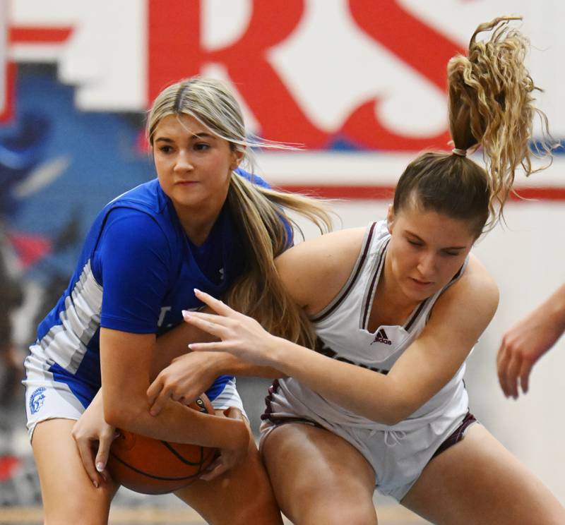 St. Francis’ Stephanie Sullivan, left, and Montini’s Peyton Farrell battle for a possession during the Class 3A Glenbard South girls basketball sectional semifinal on Tuesday, Feb. 20, 2024 in Glen Ellyn.