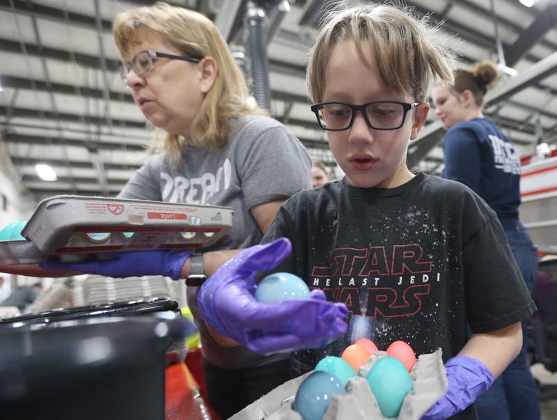 McKai Malooley dyes hard boiled Easter eggs with his grandmother Debbie Bierbom on Friday, March 29, 2024, at the Utica Fire Station for the department's annual Easter Egg Hunt. The hunt takes place 11 a.m. Saturday, March 29, in Carey Memorial Park in Utica. The Utica Fire Department has been featuring hard boiled eggs for its hunts since the 1970s.