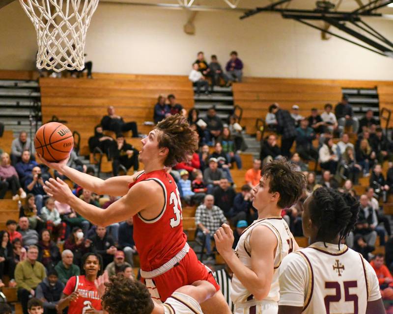 Yorkville's Bryce Salek (30) goes up for a shot and gets call for a charging foul on St. Ignatius's Philip Erickson (11) in the first quarter on Tuesday Dec. 26, 2023, at the Jack Tosh tournament held at York High School in Elmhurst.