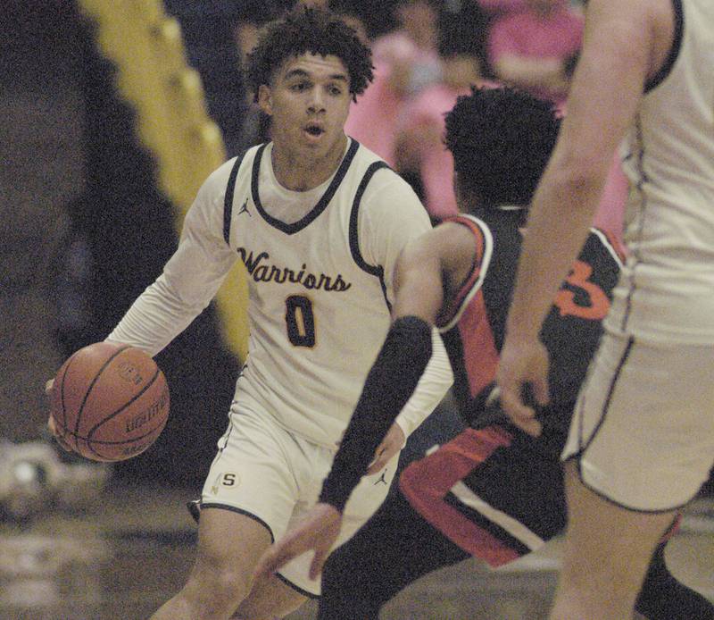 Sterling's Andre Klaver handles the ball while being defended by United Township's Dominic Rhoden during their game Friday, Feb. 9, 2024 at Musgrove Fieldhouse at Sterling High School.