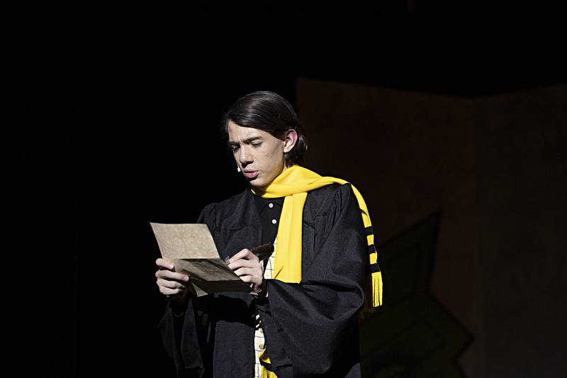 Christopher Wadsworth reads a letter during rehearsal for Dixon High School’s “Puffs” Wednesday, Nov. 1, 2023.