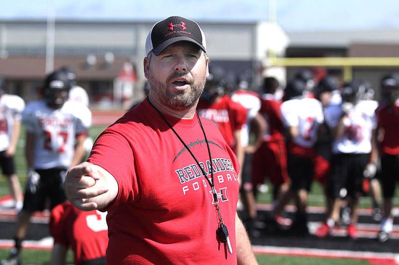 Huntley's first year football coach Matt Zimolzak directs his players during summer football camp on Wednesday, June 15, 2016.