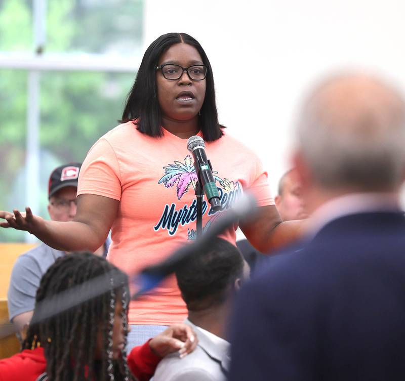 Latasha Williams, from DeKalb, asks a question of DeKalb Mayor Cohen Barnes during the informational meeting Thursday, May 18, 2023, at New Hope Missionary Baptist Church in DeKalb. The meeting centered on the the proposed plans for the vacant lot on the corner of Blackhawk Road and Hillcrest Drive in DeKalb.